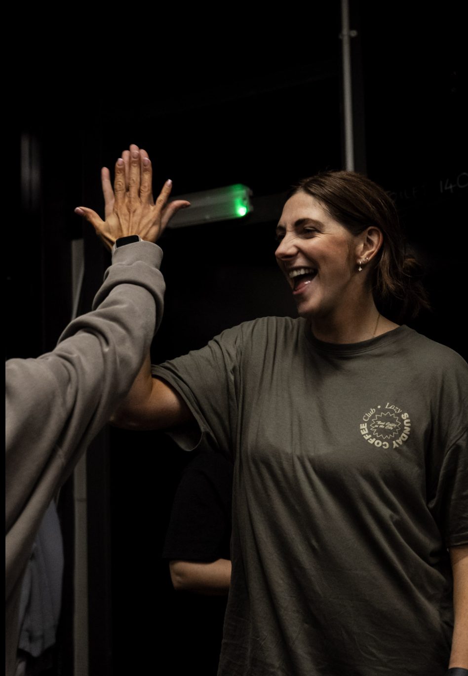 Xceed Glasgow member sharing a high-five with a coach mid-session