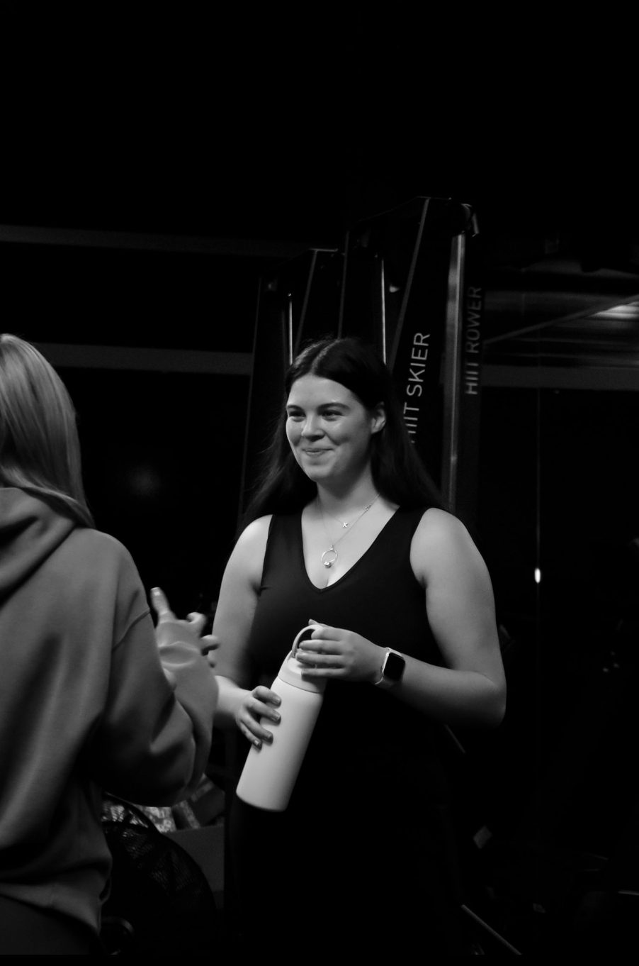 Xceed Glasgow member chatting between sets by the HIIT rower